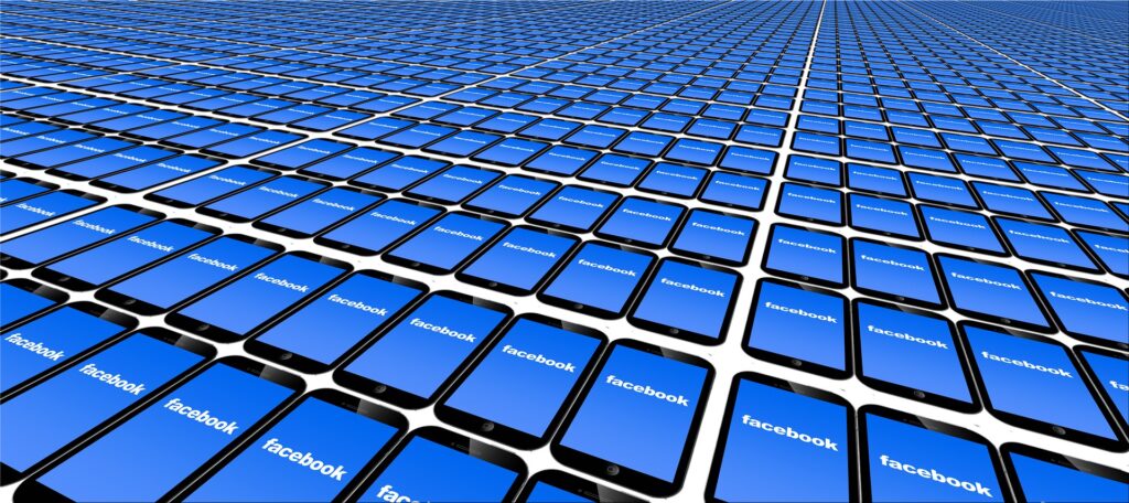 Lots of Cell Phones with Facebook on the Screens | Spiritual Business Coach